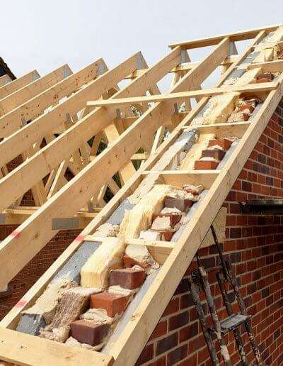 A detailed shot showing the expert installation of timber roof trusses by ETE Ltd