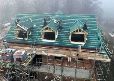image shows workers installing roof trusses